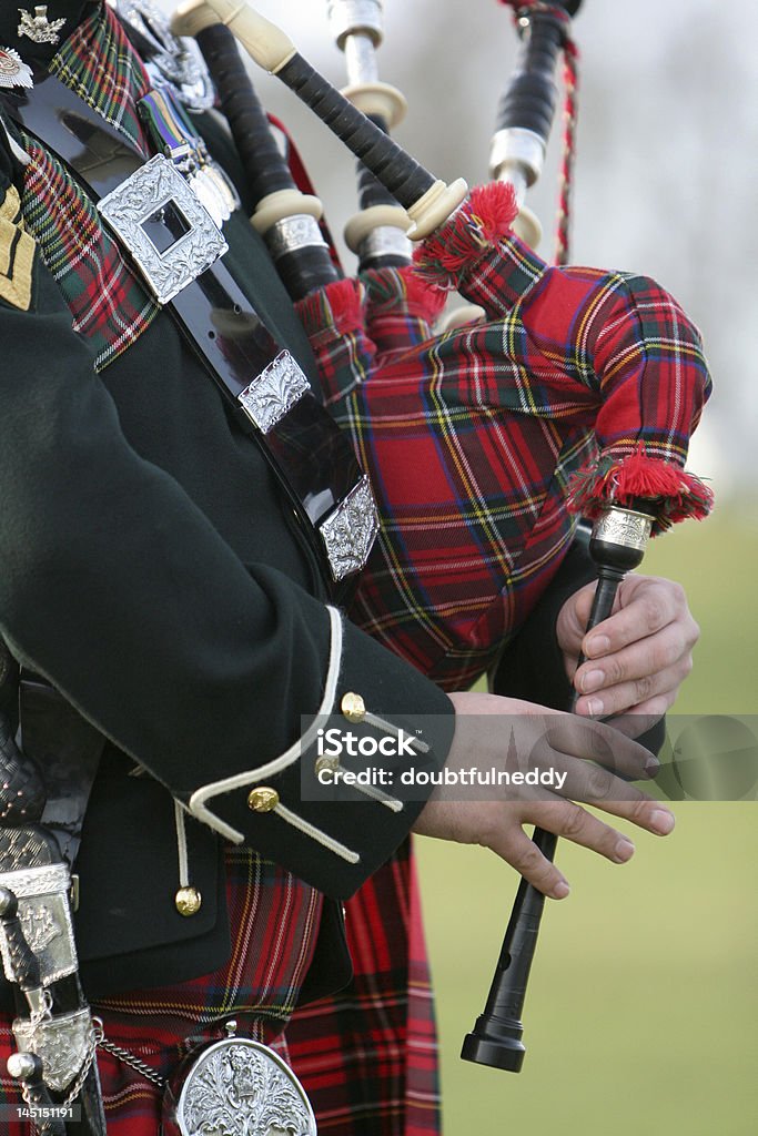 Scottish  Bag Piper Wonderful rich colours of tartan worn by the Scottish Bag Piper Bagpipe Stock Photo