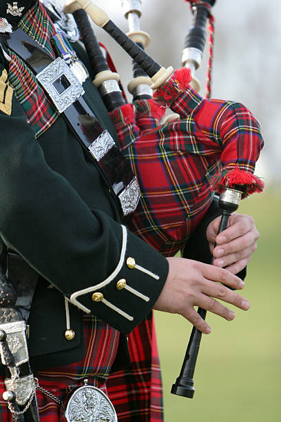 Scottish  Bag Piper Wonderful rich colours of tartan worn by the Scottish Bag Piper kilt stock pictures, royalty-free photos & images
