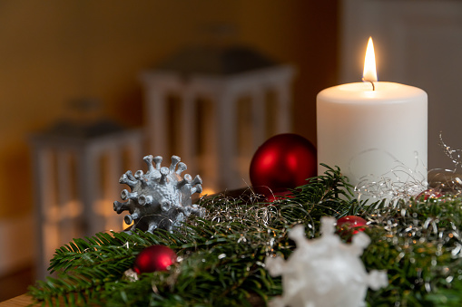 Red candle light Christmas candlelight on glowing flame sparkling red background blurred