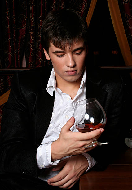 istock young man with a glass of cognac 145151880