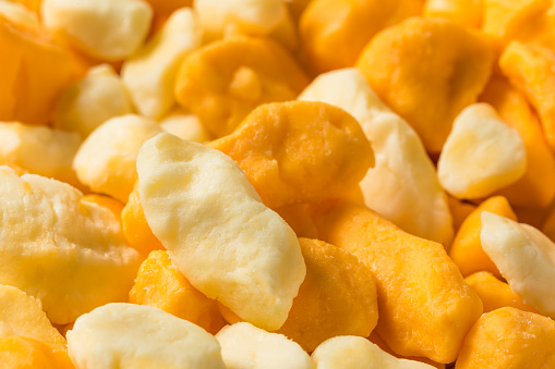 Raw Organic Yellow and White Cheese Curds in a Bowl
