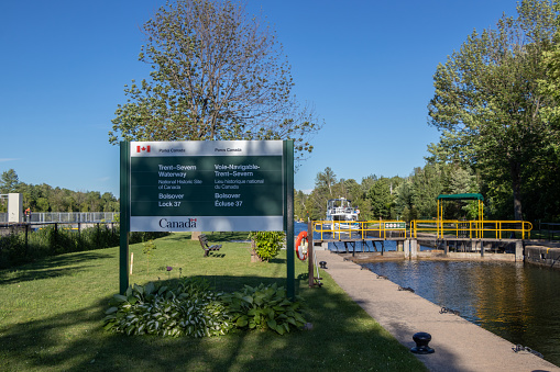 Trent Severn Waterway Bolsover Lock 37, Ontario, Canada - June 22, 2022: Lock 37 is one of the deepest fully manual stations on the waterway. There are two walls designated on the upper side for mooring an a popular wing wall by the dam.
