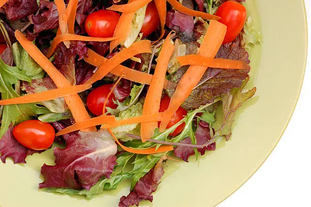 Healthy salad of greens, carrots and tomatoes