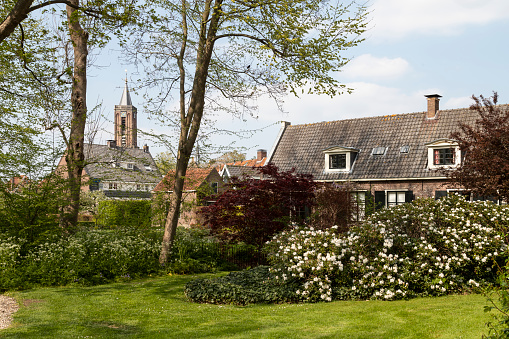 View of the picturesque village of Loenen aan de Vecht with the church tower in the background in the Netherlands.