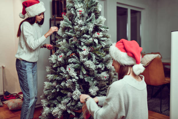 istock Females Completing Christmas Tree Decoration 1451534478