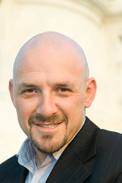 istock Smiling Caucasian Man, Shaved Head, Goatee, Isolated Background 145153520