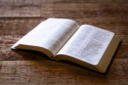 This is a photograph of a Bible on a retro wood background