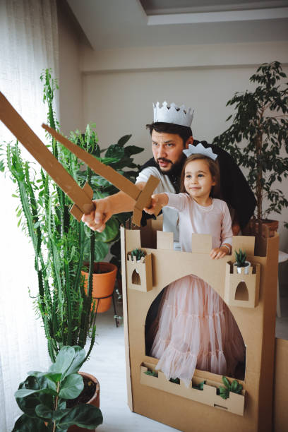 Father Playing Exciting Adventure Game With Daughter