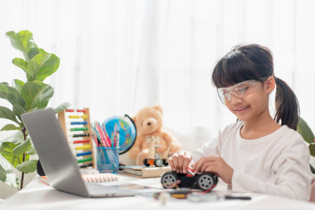 istock Asia students learn at home in coding robot cars and electronic board cables in STEM, STEAM, mathematics engineering science technology computer code in robotics for kids concept. 1451537835