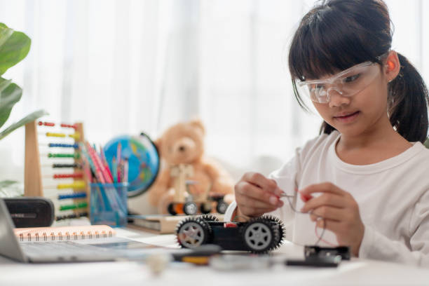 istock Asia students learn at home in coding robot cars and electronic board cables in STEM, STEAM, mathematics engineering science technology computer code in robotics for kids concept. 1451537848