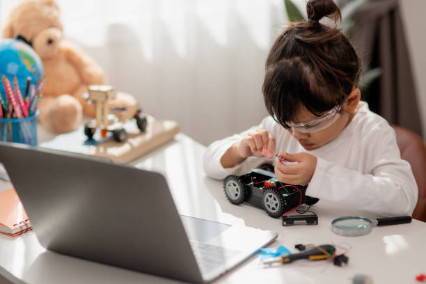 istock Asia students learn at home in coding robot cars and electronic board cables in STEM, STEAM, mathematics engineering science technology computer code in robotics for kids concept. 1451537877