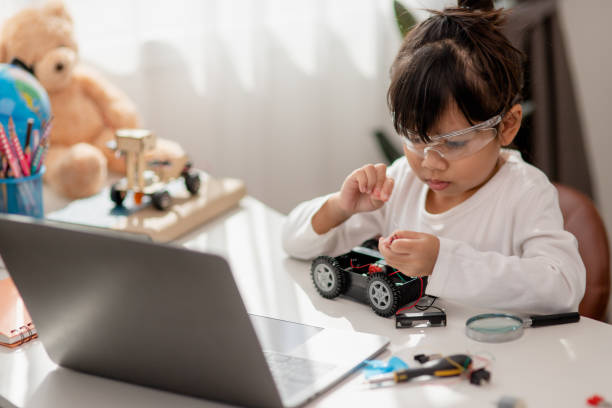 istock Asia students learn at home in coding robot cars and electronic board cables in STEM, STEAM, mathematics engineering science technology computer code in robotics for kids concept. 1451537884
