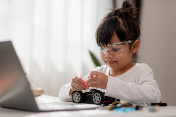 istock Asia students learn at home in coding robot cars and electronic board cables in STEM, STEAM, mathematics engineering science technology computer code in robotics for kids concept. 1451537915