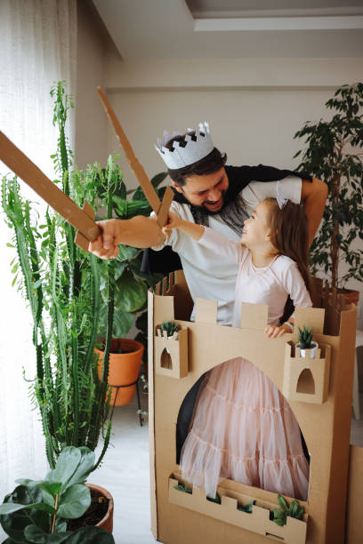 istock Father Playing Exciting Adventure Game With Daughter 1451538868