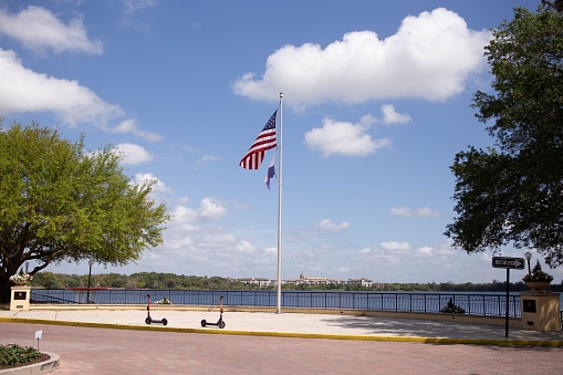 A closeup view of an American flag at a coastline of Baldwin lake