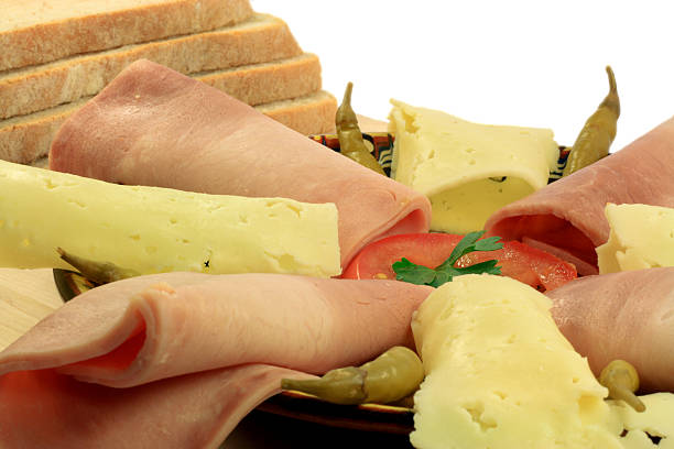 Euro Style Bred, Slices Ham and Yellow cheese,  Tomato, Pickled hot peppers and Sprig Parsley.