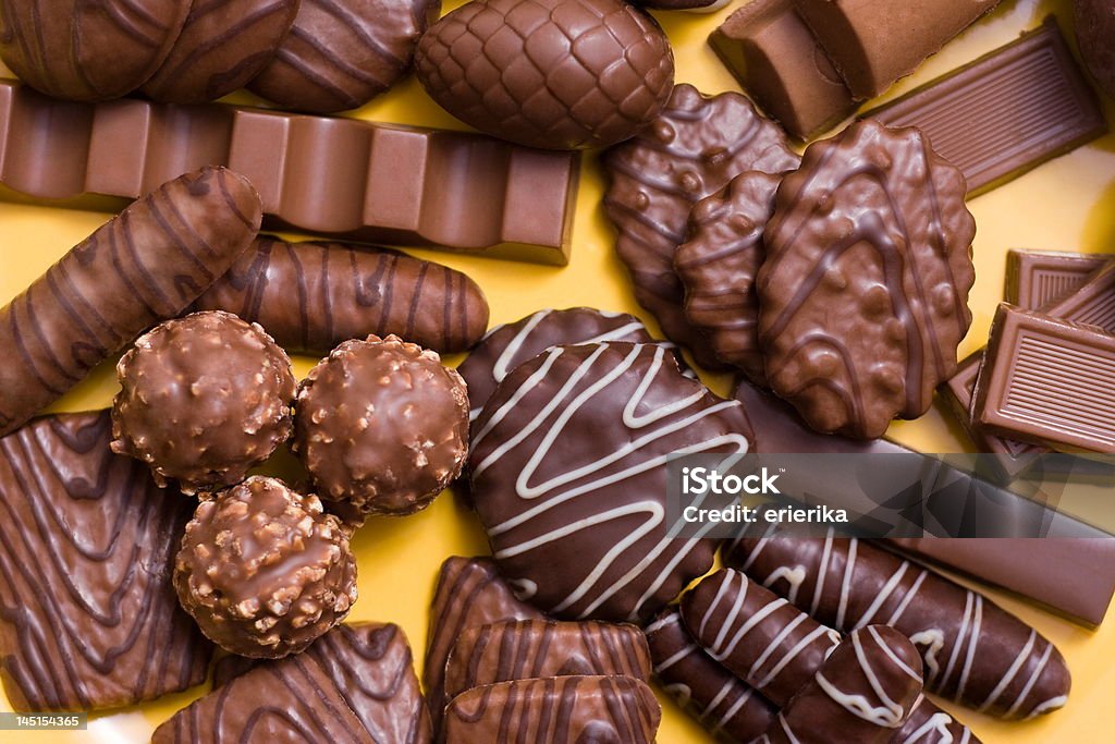 Assorted chocolates Top view of assorted chocolates in yelow tray Backgrounds Stock Photo