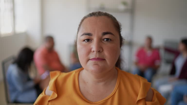 Portrait of mid adult woman in a meeting at community center