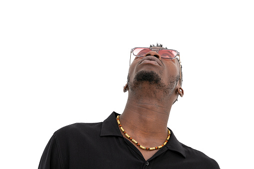 African-American man in black shirt wearing sunglasses against white background.