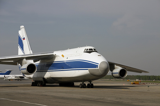 The Enormous airplane stands on platform and expects the cargo. This is Antonov-124 \