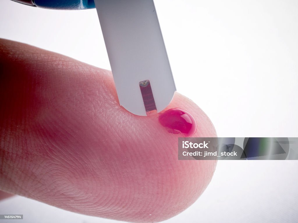 Diabetic, Glucose, Sugar Test finger with blood drop Diabetic, Glucose, Blood Sugar Test strip, finger with blood drop. Analyzing Stock Photo