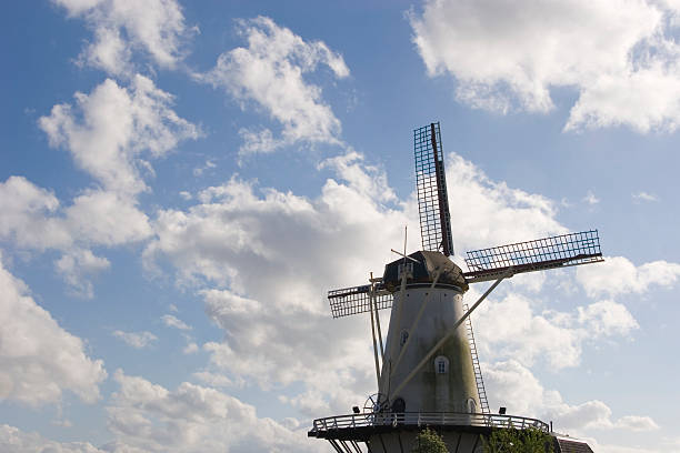 istock Old Windmill in front of a cloudy sunny sky 145155139