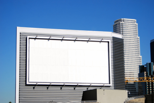 Blank white billboard is available for your corporate advertising in downtown Los Angeles, California.