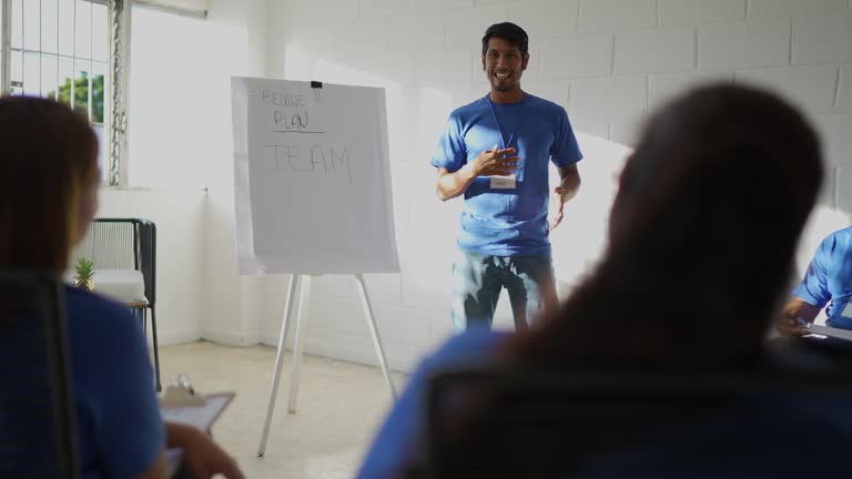 Mid adult man doing a presentation during a meeting (or group therapy)