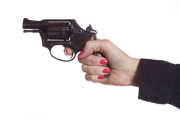 istock Female hand shooting a black revolver  145157591