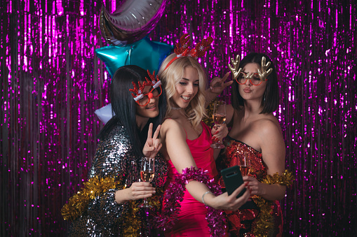 Three young women have fun at a New Year's party