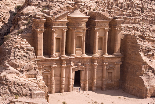 The famous Monastery at Petra, Jordan. Cut out of the red stone cliff side, it is located high in the mountains surrounding Petra.  Petra, Jordan was voted one of the Seven Wonders of the Modern World.  Petra was rediscovered in the 19th century by a Swiss Explorer.  The image is taken from a high angle above the Monestery.