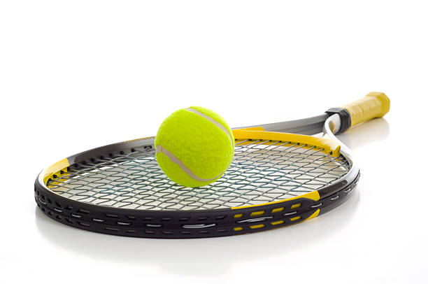 Tennis Ball and Racket A new tennis ball and racket on a white background with copy space tennis racket stock pictures, royalty-free photos & images
