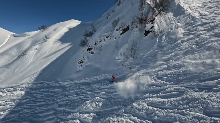 Mountain ski extreme sport sportsman freeride trick maneuver from snow summit ridge aerial view