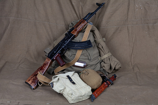 Mobilization in russia 2022. Kalashnikov gun with primitive WW2 pattern soviet army equipment.