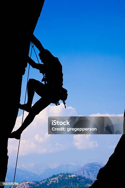Silhouette Of Rock Climber Clinging To A Cliff Stock Photo - Download Image Now - Achievement, Adventure, At The Edge Of