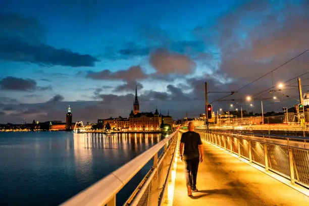 Photo of Solo traveler walking Stockholm empty streets at night