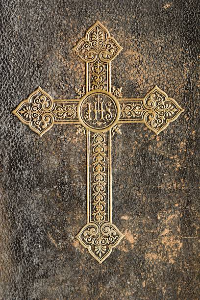 istock cross on the old  prayer-book 145159814