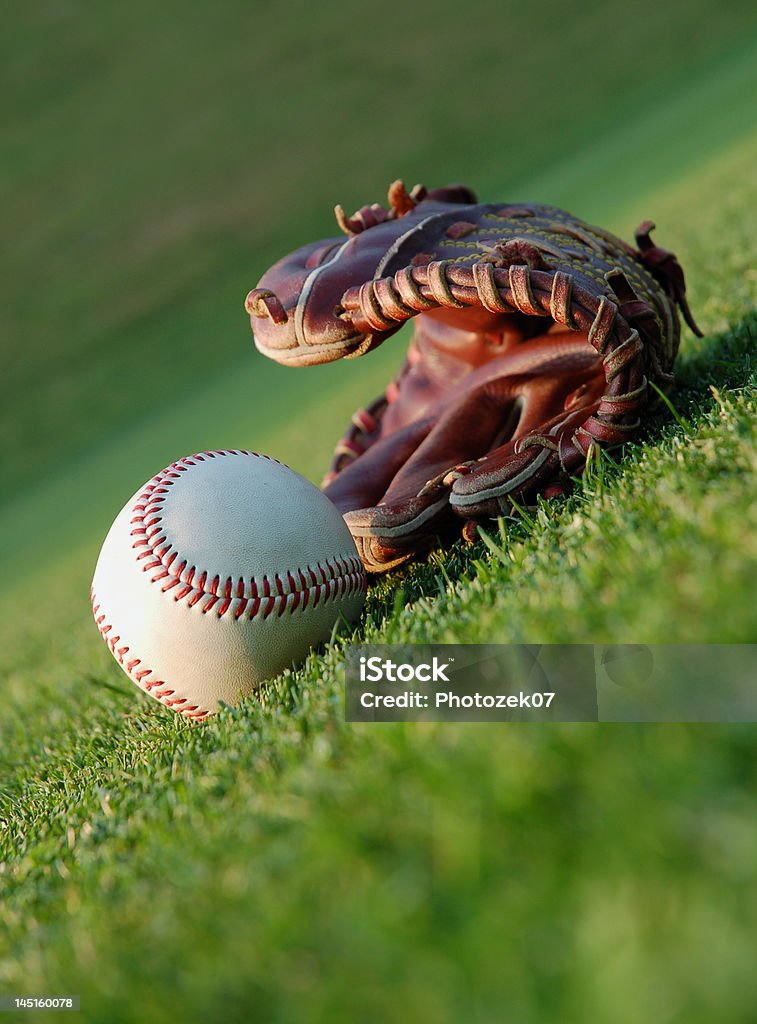 Baseball on the field Close up of a baseball glove and ball on the field Activity Stock Photo