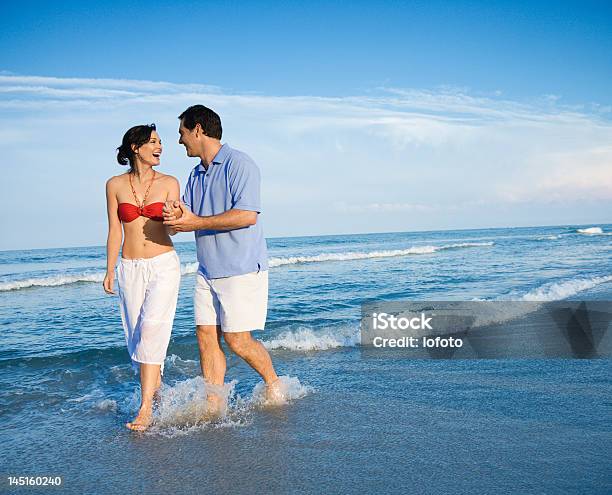 Pareja Caminando En Las Olas Foto de stock y más banco de imágenes de Carolina del Norte - Estado de los EE. UU. - Carolina del Norte - Estado de los EE. UU., Personas, Playa