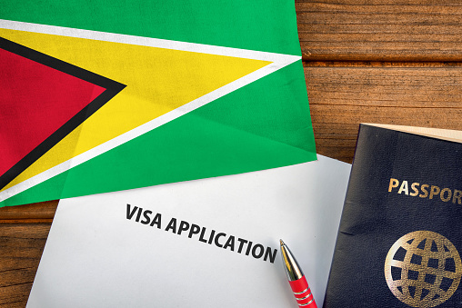 Visa application form, passport and flag of Guyana