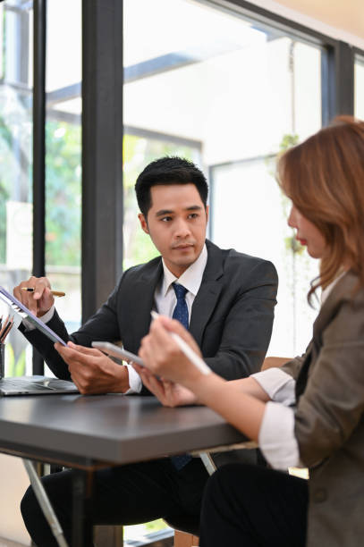 istock Professional Asian businessman focusing on analyzing financial sales data with his assistant 1451611298