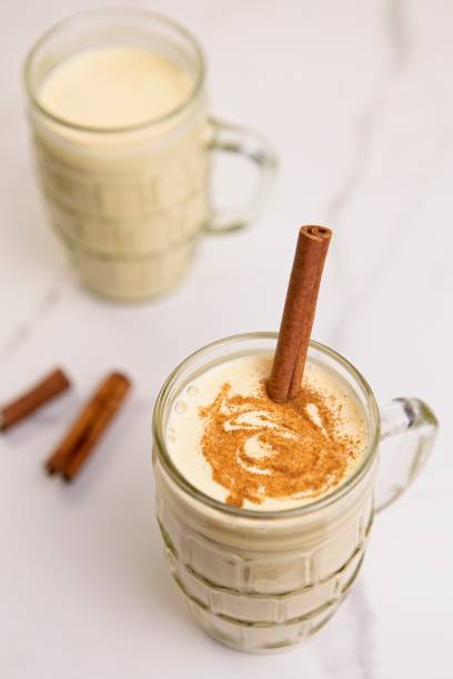 istock Close up of eggnog with a cinnamon stick. 1451613171
