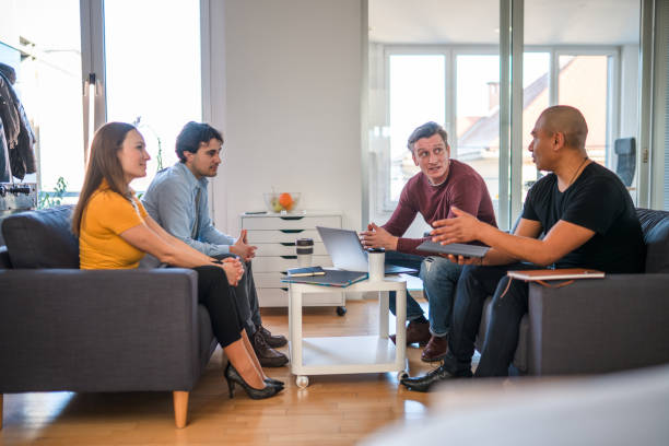 istock Latin Mature Man Explaining Ideas to Creative Multiracial Small Team 1451614555