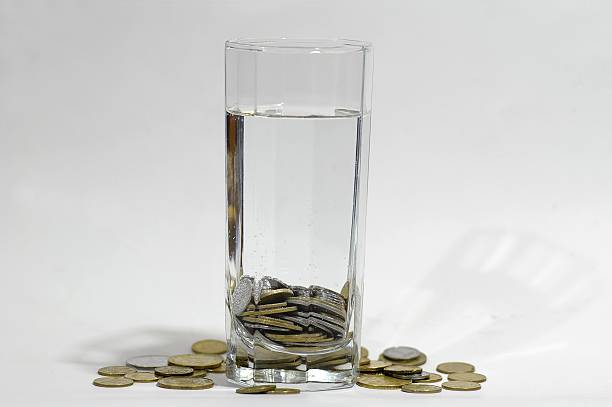 istock Coins in a glass of water 145161510
