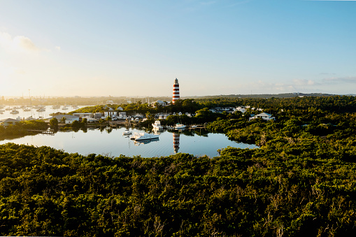 Areal view of beautiful Elbow Reef Lighthouse in Abaco Island Bahamas reflecting in the bay