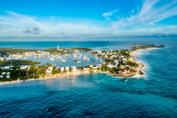 Aerial view of Hope Town, Great Abaco Island, Bahamas Drone view of harbor bay with many yacht on mooring balls, blue sky and  waters bahamas stock pictures, royalty-free photos & images