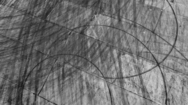istock Tire tracks texture and background, Asphalt texture with line and tire marks, Automobile automotive tire skid mark on race track, Abstract texture car drift tire skid mark. 1451619809