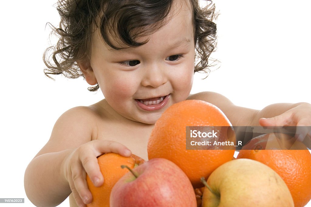 Baby with fruits. Baby with fruits,isolated on a white background. 12-17 Months Stock Photo