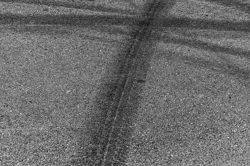 Tire tracks texture and background, Asphalt texture with line and tire marks, Automobile automotive tire skid mark on race track, Abstract texture car drift tire skid mark.