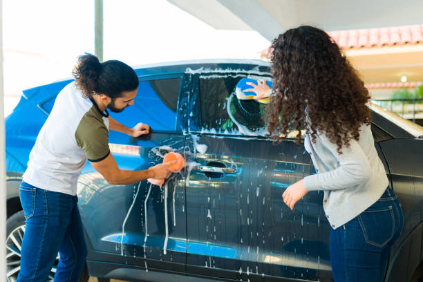 istock Young couple seen from behind washing the car 1451623192